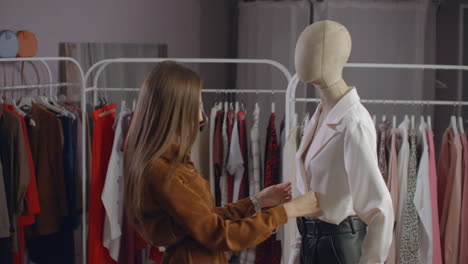 A-beautiful-woman-chooses-clothes-in-a-branded-clothing-showroom.